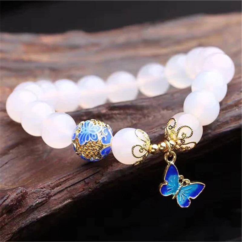 Women's handmade spiritual bracelet featuring white agate beads and a delicate butterfly
