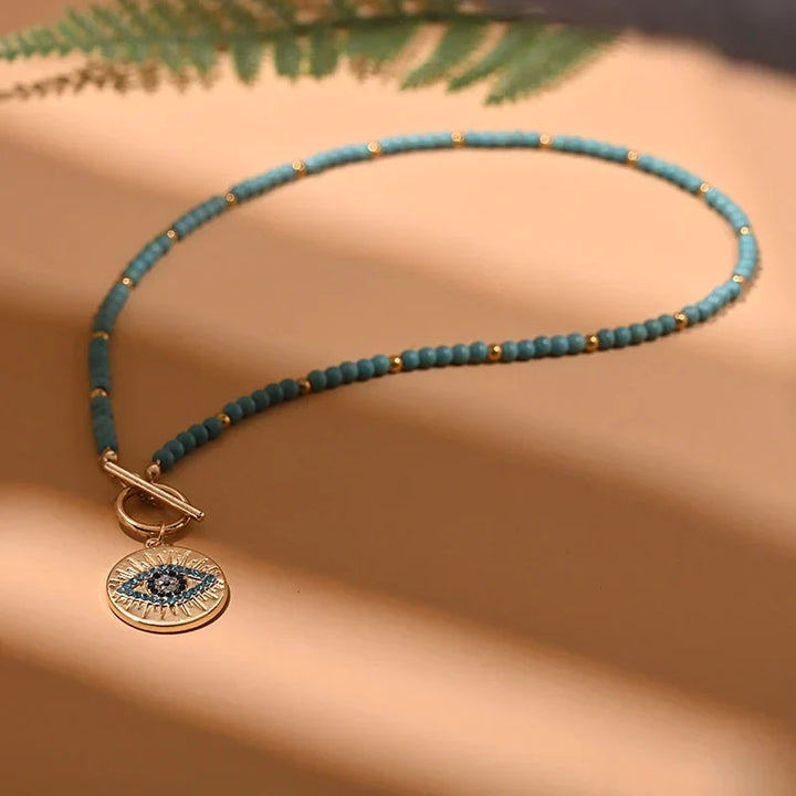 Elegant women's evil eye pearl choker necklace, a stylish accessory providing spiritual protection.