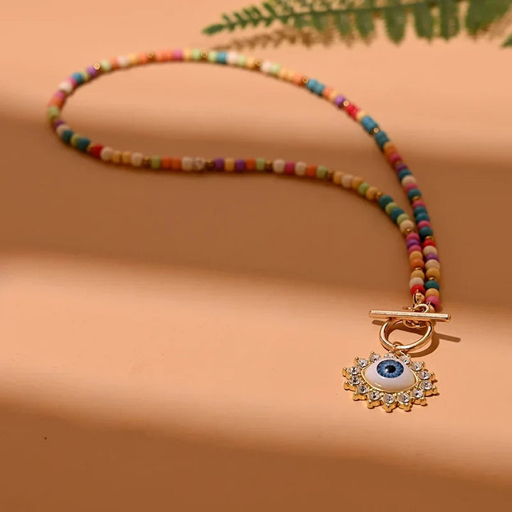 Trendy women's pearl choker necklace featuring an evil eye for style, protection, and good luck.