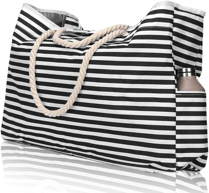 Woman carrying an extra large waterproof beach tote with bonus pouch, ready for beach, pool or summer travel.