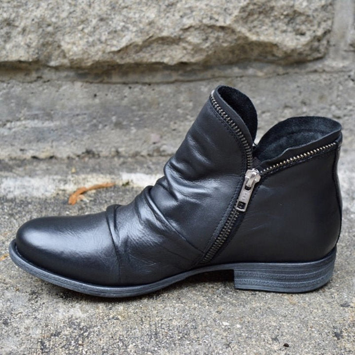 Elegant women's ankle boots, chic design with a functional zipper. Ideal fashionable footwear for winter.