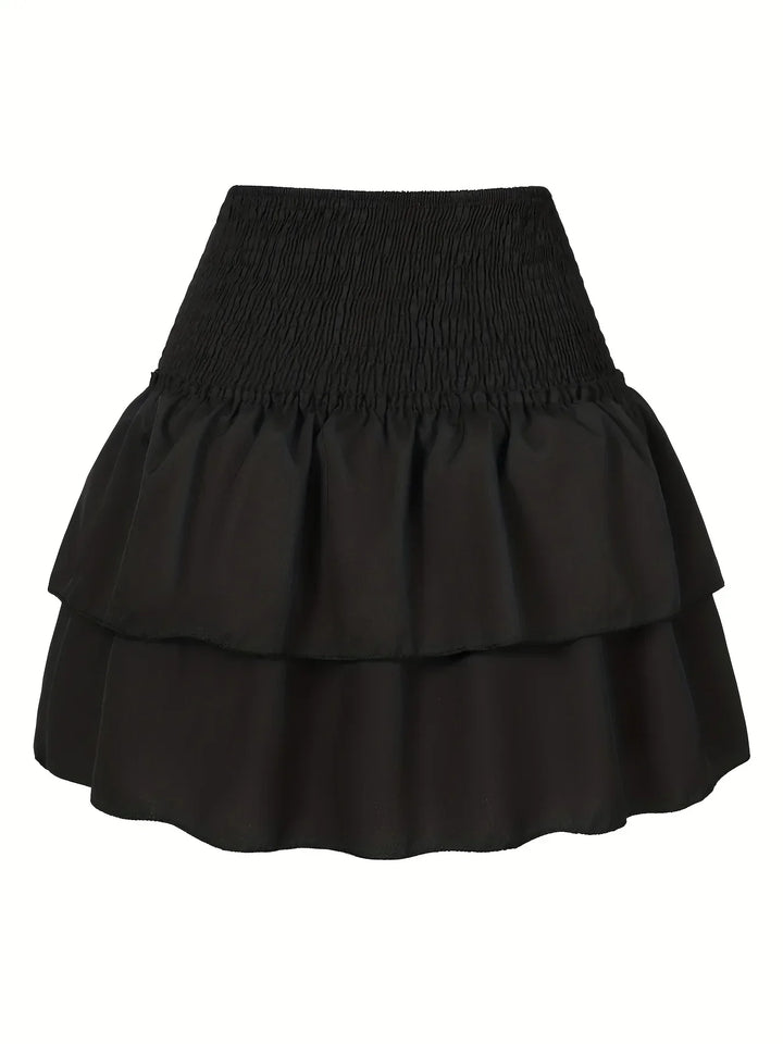 Elegant women's pleated skirt with layered hem, a versatile midi for fashion-forward spring outfits.