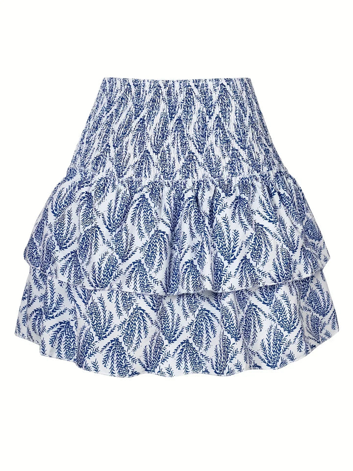 Fashionable women's pleated midi skirt, featuring a flattering fit and stylish layered hem for a chic look.