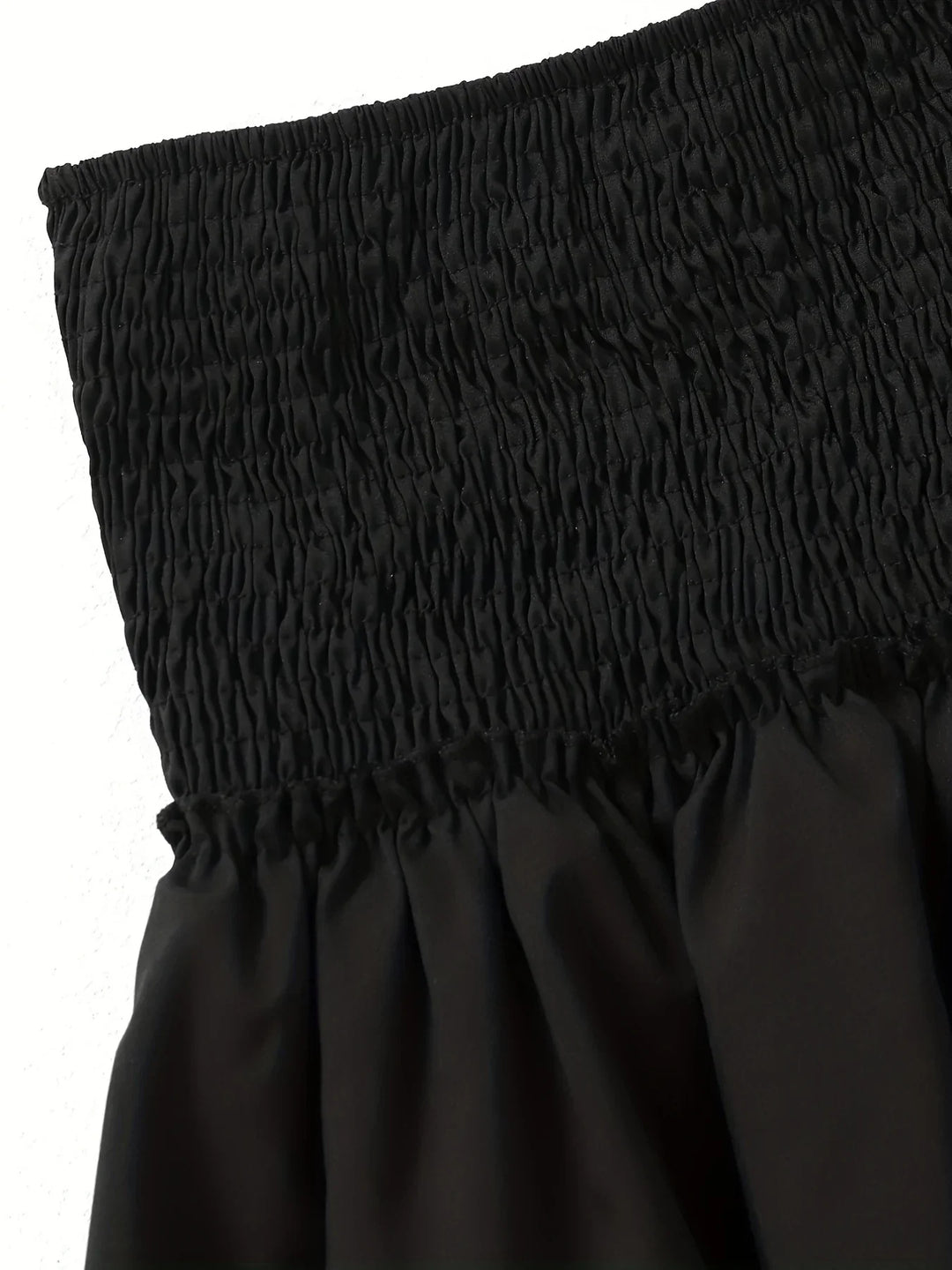 Women's elegant pleated midi skirt with a fashionable layered hem, designed for a flattering and chic spring look.