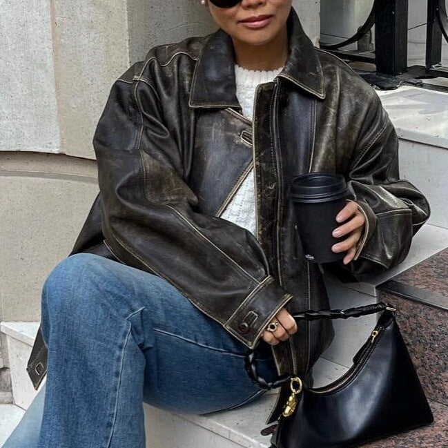 Women's brown faux leather jacket, featuring a timeless retro design for elegant outfits.