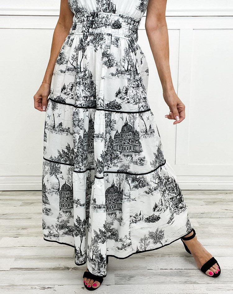Beautiful women's flowing maxi dress with a sophisticated toile print, smocked waist, and tiered skirt.