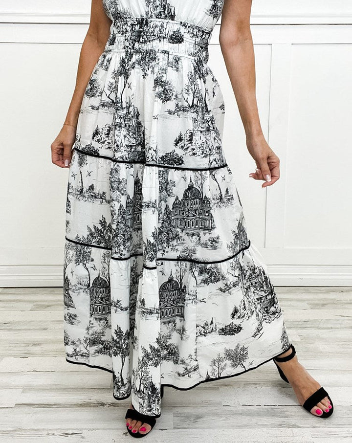 Beautiful women's flowing maxi dress with a sophisticated toile print, smocked waist, and tiered skirt.