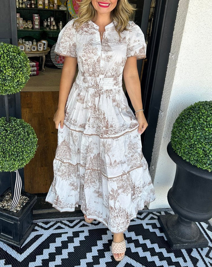Elegant women's toile print maxi dress. Classic V-neck, smocked waist, and tiered skirt for a feminine look.