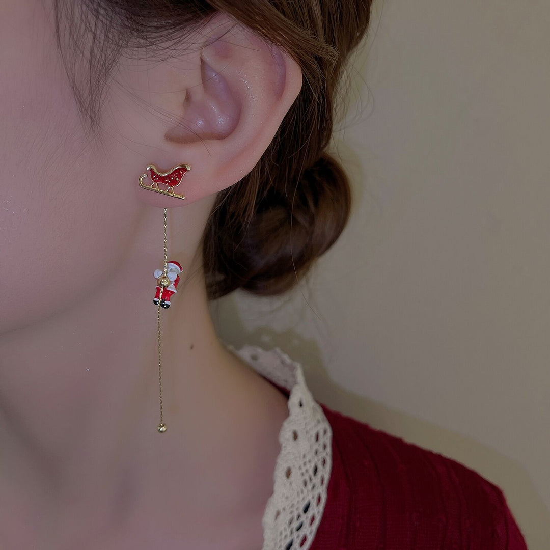 Close-up of women's festive Santa head tassel dangle earrings for Christmas.