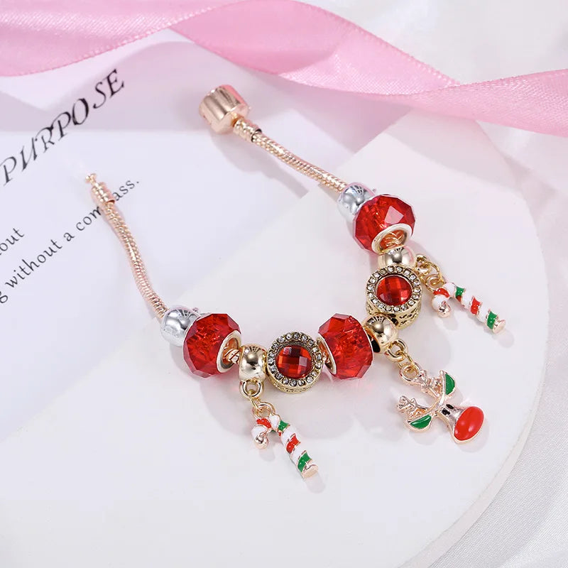 Holiday women's charm bracelet with festive candy cane and Christmas tree charms. Ideal for Christmas season parties.