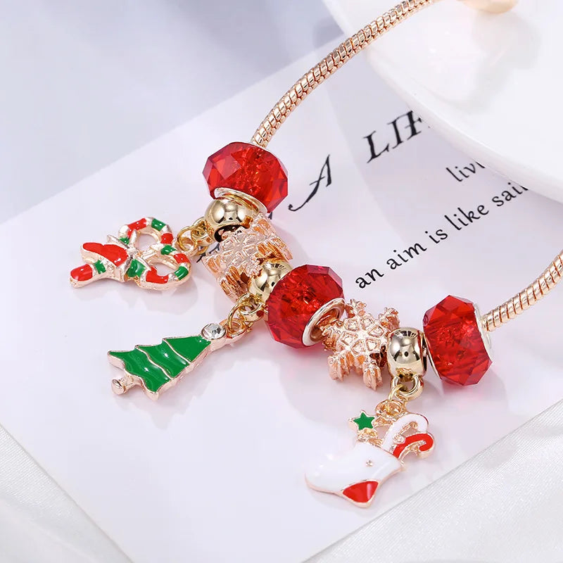 Women's festive silver charm bracelet, adorned with sparkling candy cane, reindeer & Christmas tree charms for holidays.