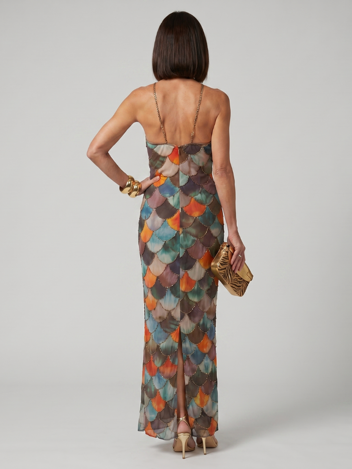 Stylish women's fitted halter maxi dress with a vibrant geometric scale print. Chic for summer events.