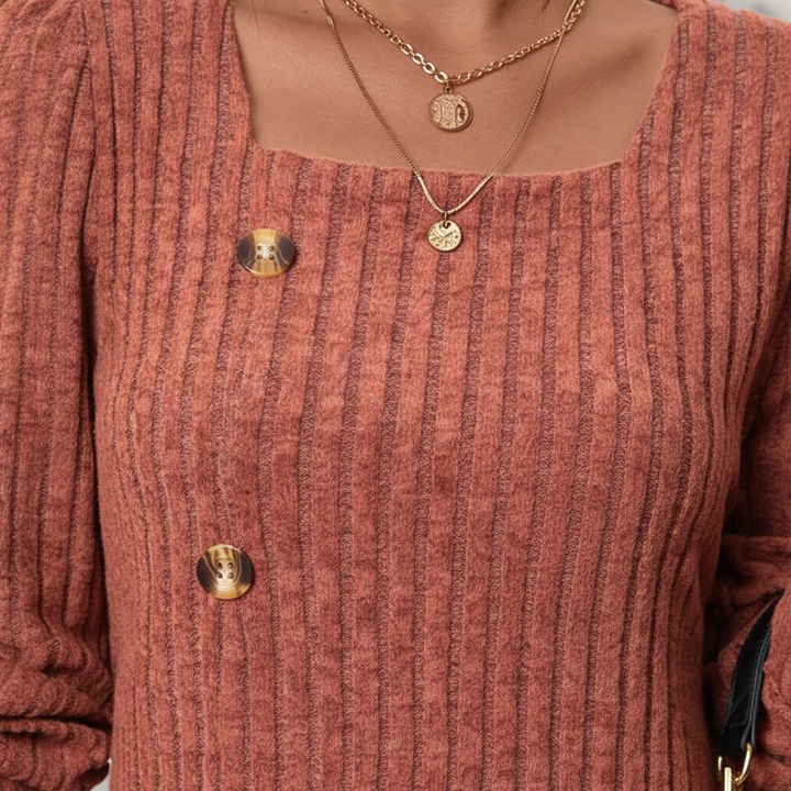 Close-up of the textured ribbed knit on a women's long sleeve top, showcasing cotton-blend quality.