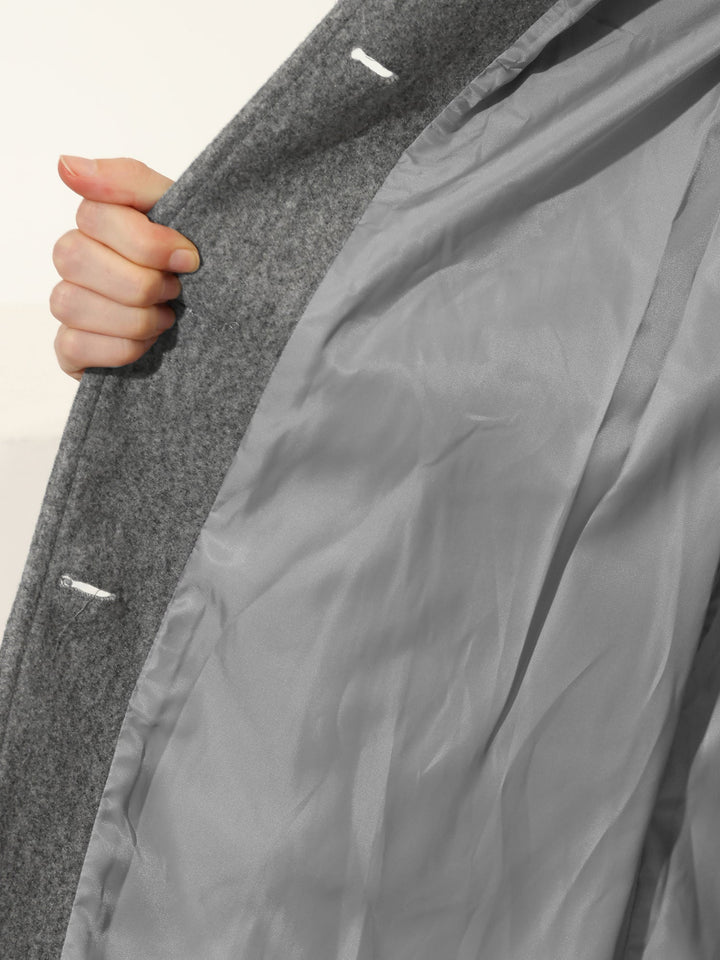 Versatile women's fitted trenchcoat, a classic long sleeve jacket with button closure for professional elegance.