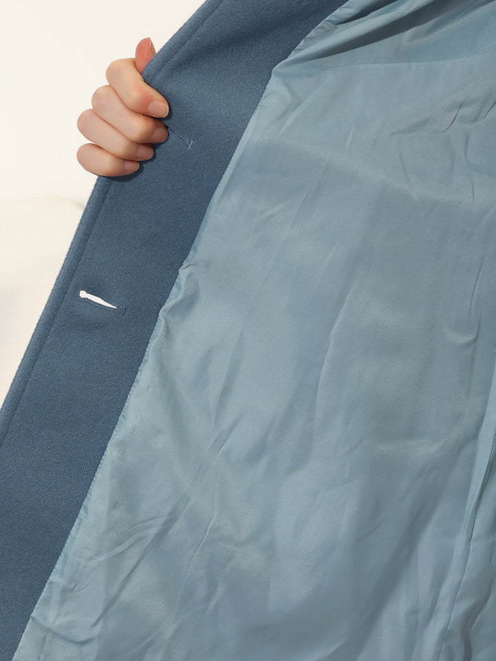 Close-up of elegant women's trenchcoat, fitted with classic button closure & structured collar, professional look.
