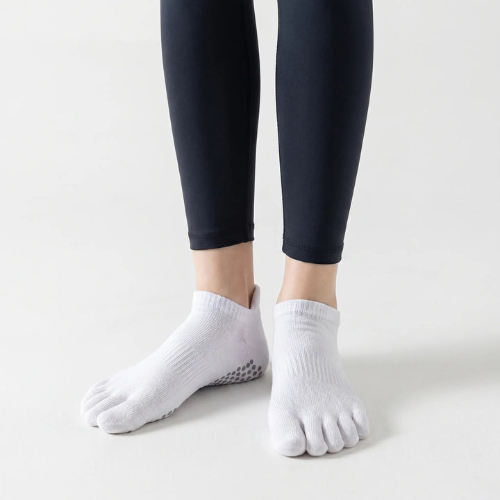 Close-up of women's five-toe grip pilates socks. Non-slip sole texture for secure footing during yoga & studio workouts.