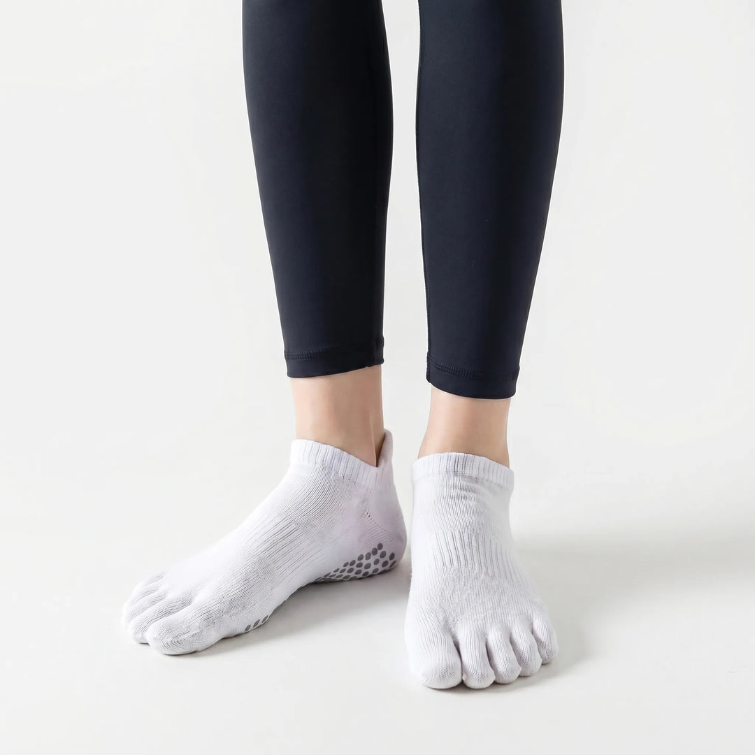 Pair of women's five-toe grip athletic socks. Durable non-slip studio socks for yoga, pilates, and activewear workouts.