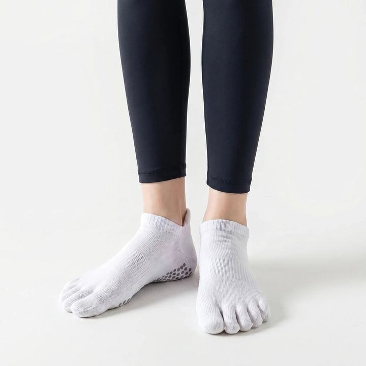 Pair of women's five-toe grip athletic socks. Durable non-slip studio socks for yoga, pilates, and activewear workouts.