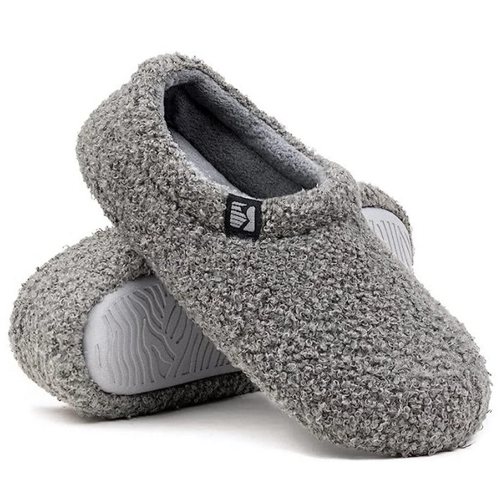 Soft fleeced women's slippers, closed-back, offering plush indoor comfort & quiet soles.