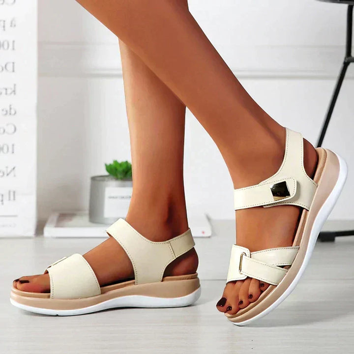 Close-up of comfortable women's orthopedic sandals, featuring arch support and adjustable strap for summer wear