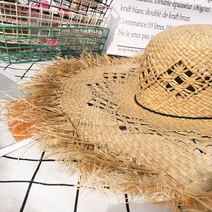Stylish women's floppy Panama hat made of straw, featuring a decorative band. Great for sun