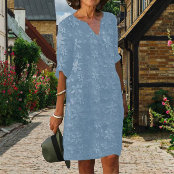 Women's shift midi dress with delicate floral appliqué, relaxed notch neck, and practical 3/4 sleeves.