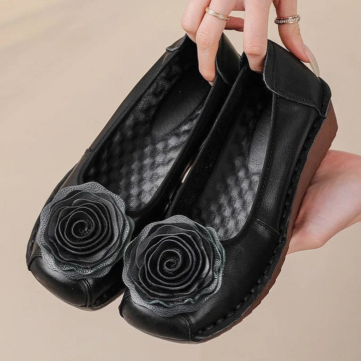 Stylish women's comfort loafers with intricate floral appliqué detail, easy slip-on design.