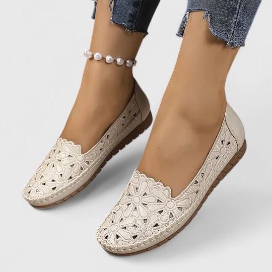 Lightweight women's walk flats with elegant floral cutouts, comfortable slip-on ballet style for daily wear.