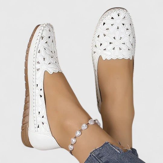 Feminine women's ballet flats with intricate floral cutout design & comfortable round toe.