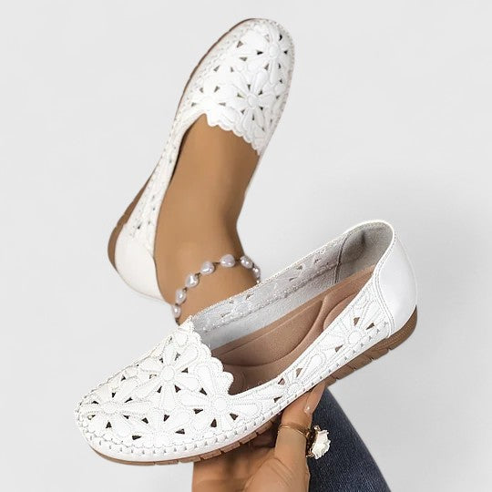 Women's everyday ballet flats with a unique floral cutout pattern and comfortable slip-on style.