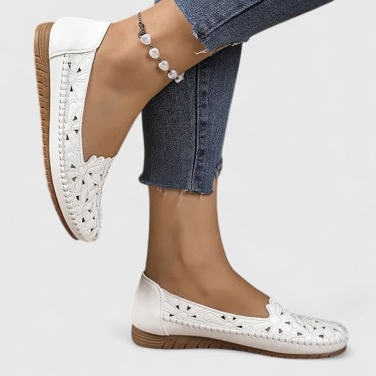 Versatile women's slip-on ballet flats with attractive floral cutout detailing, great for all-day comfort.