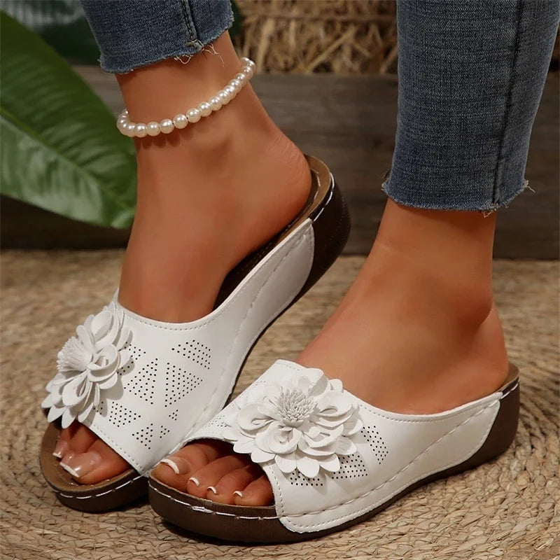 Stylish women's floral Elarie slip-on sandals with intricate applique design.