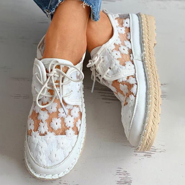 Women's supportive slip-on shoes, beautifully embroidered with flowers, ensuring comfort and style.
