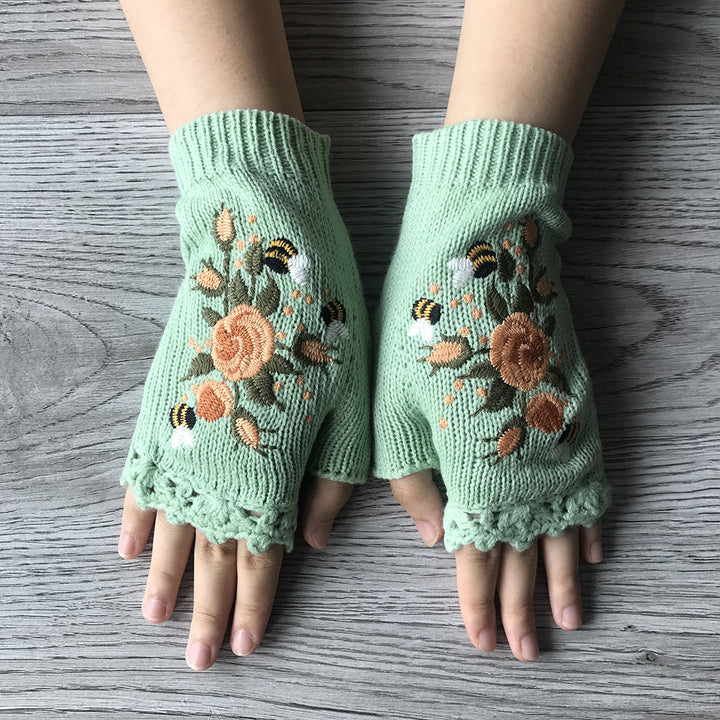 Elegant women's fingerless gloves, knit for warmth, featuring beautiful floral embroidery.
