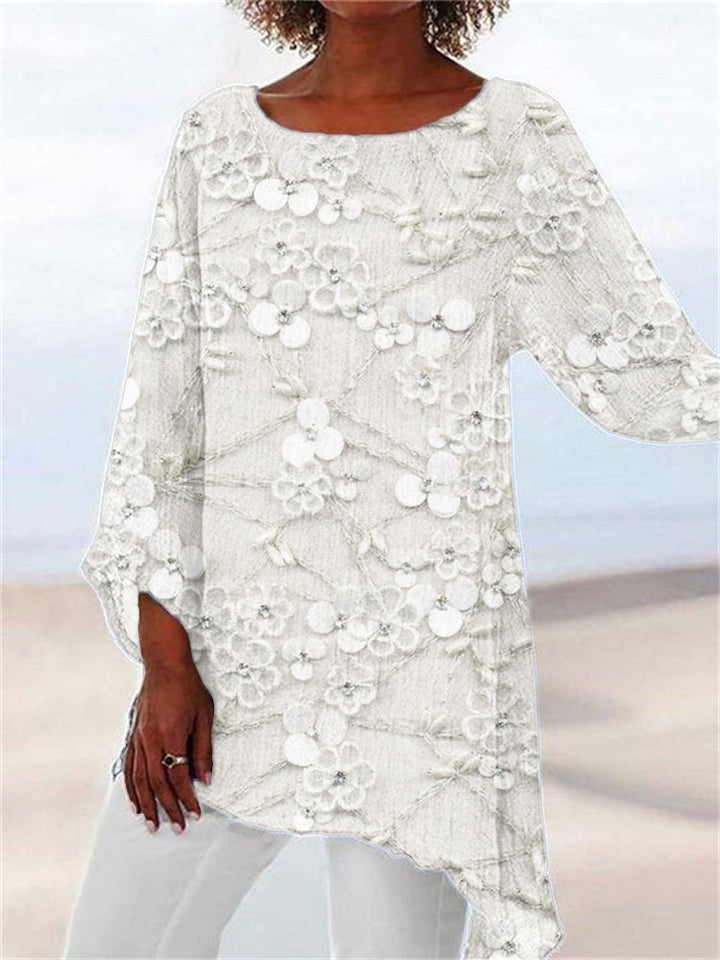 Stylish women's tunic top featuring delicate floral embroidery & an asymmetrical hem. Ideal for casual spring & fall outfits.