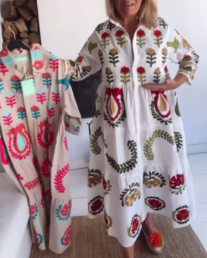 Elegant women's flowy midi dress with a striking floral graphic, great for vacation wear.