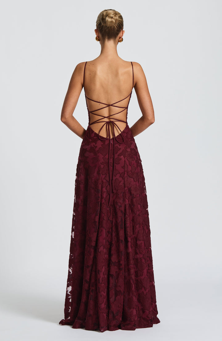 Women's A-line floral maxi dress with a flowing silhouette, waterfall neckline, and sexy lace-up back.