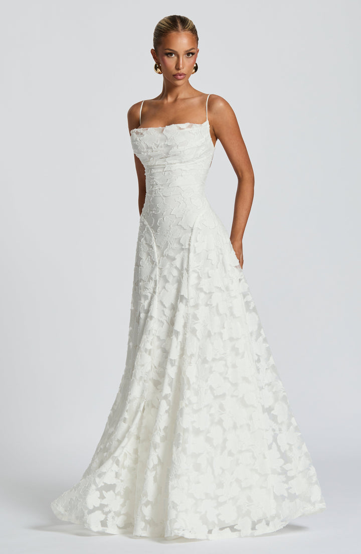 Back view of a women's floral maxi dress, highlighting the intricate lace-up back detail.