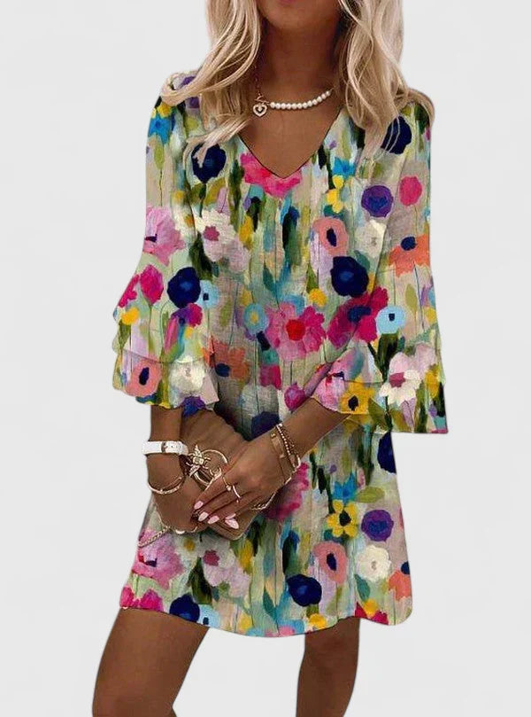 Women's floral mini dress with ruffled sleeves and V-neck. Perfect lightweight summer style for casual wear.