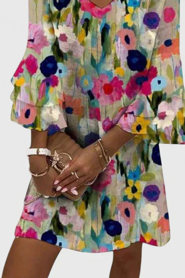Flowy women's floral mini dress, short V-neck summer style with delicate ruffled sleeves. Ideal for warm weather.