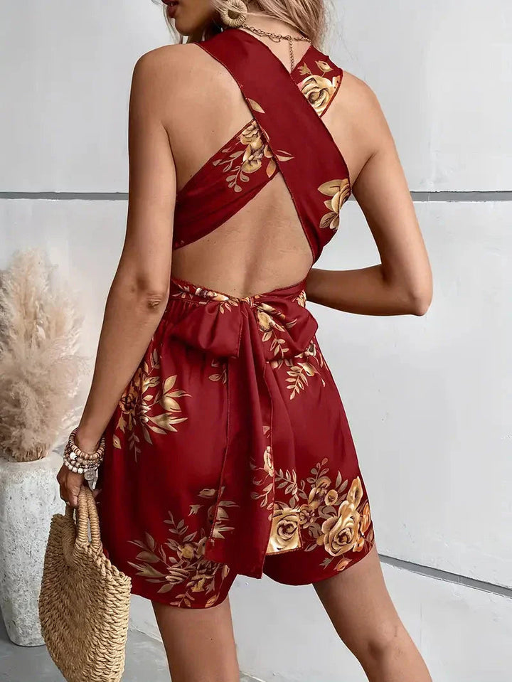 Lightweight women's floral mini romper, designed with an open back for breathable vacation wear.