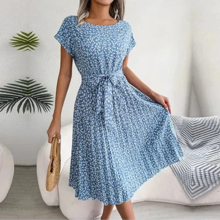 Women's floral pleated midi dress with graceful movement, ideal for summer events.