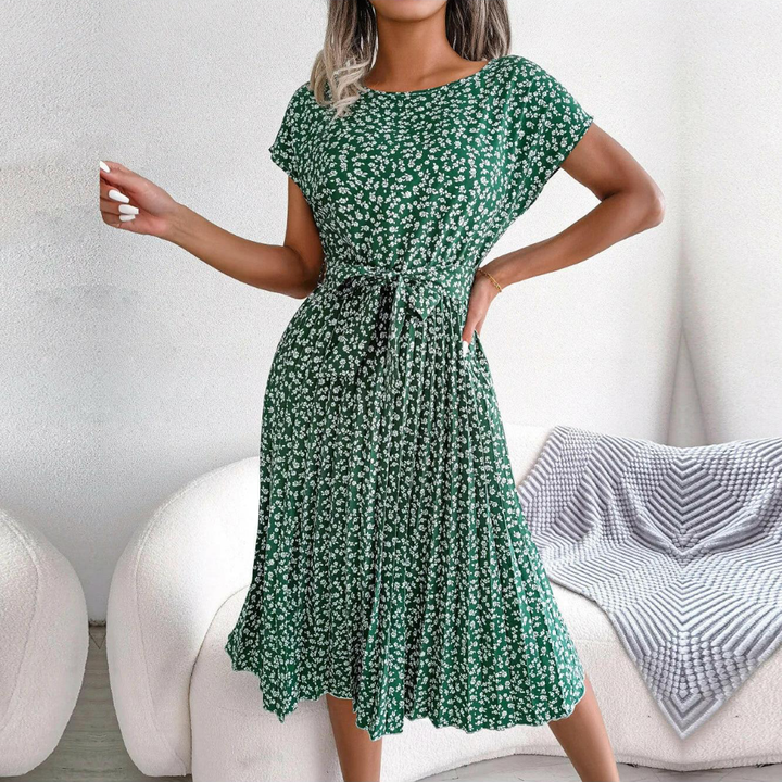 Flowy women's floral midi dress with delicate pleats, perfect for elegant spring occasions.
