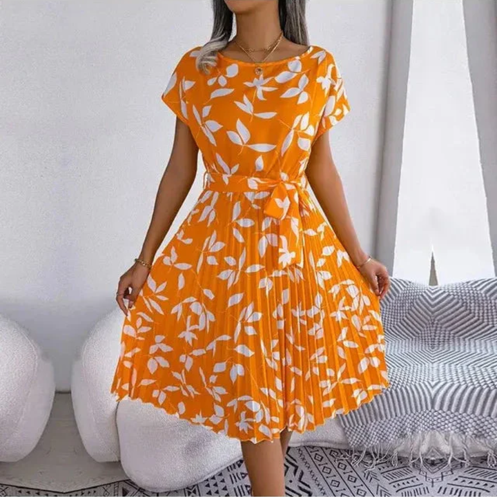 Comfortable & stylish women's floral midi dress featuring elegant pleats, great for spring fashion.