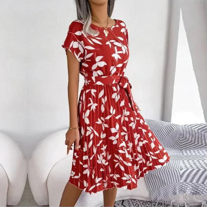 Elegant women's midi dress with vibrant floral print and flowing pleats, ideal for spring/summer.