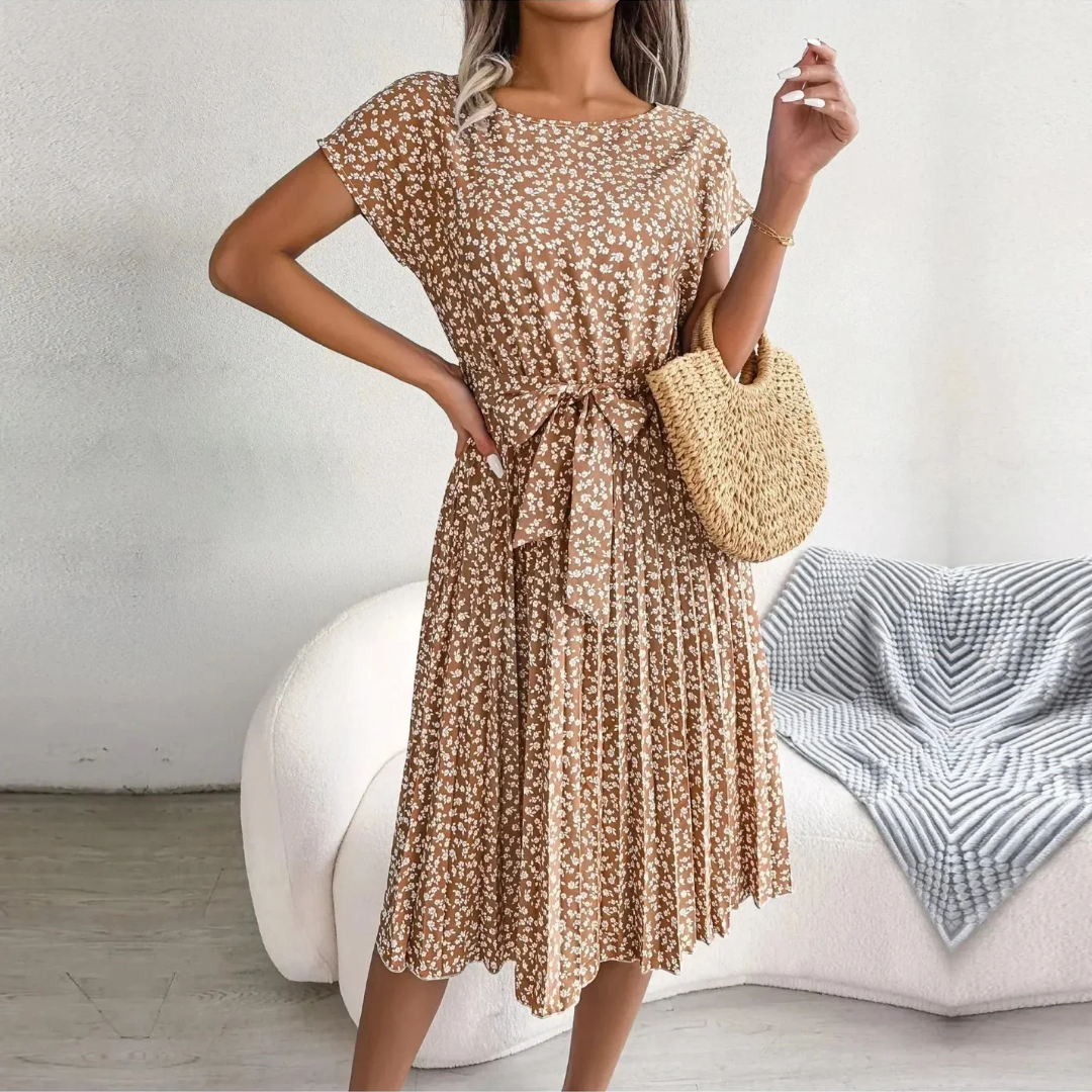Graceful women's floral pleated midi dress, showcasing its elegant flow for spring and summer fashion.