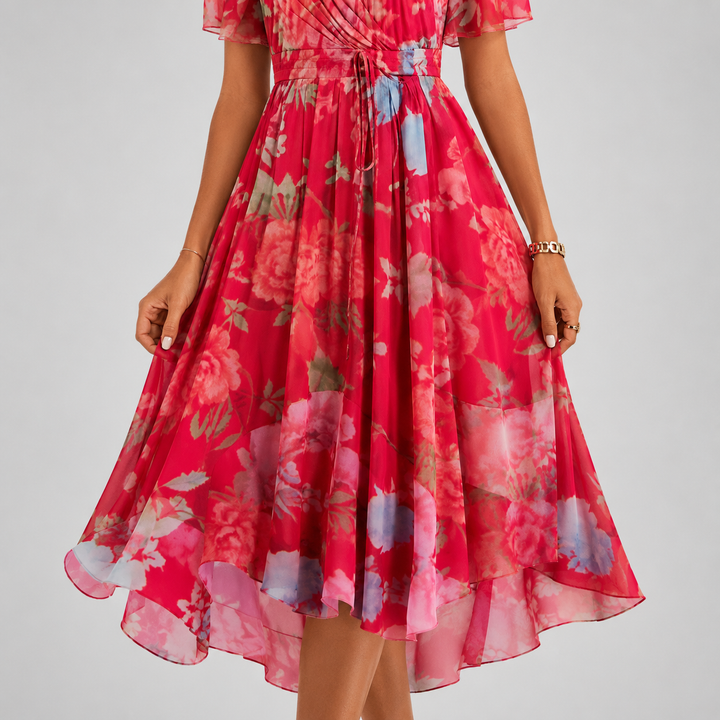 Stylish women's floral midi dress, V-neck, flutter sleeves, and high-low hem for summer.