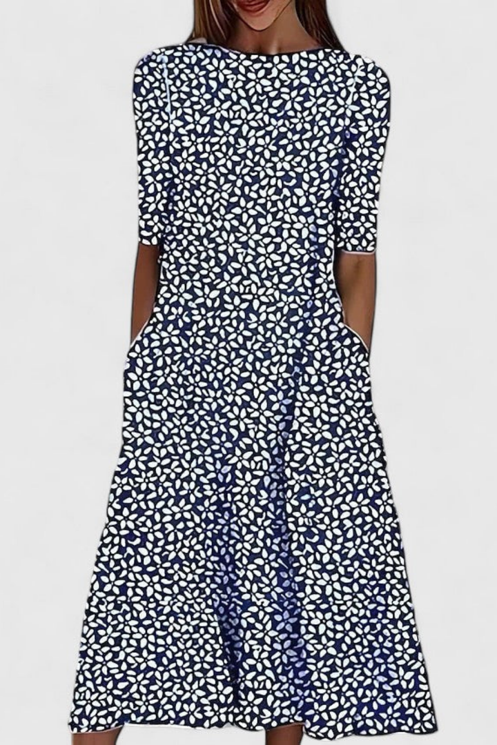 Relaxed fit women's floral print A-line midi dress featuring a round neck & short sleeves. Flowy casual summer style.