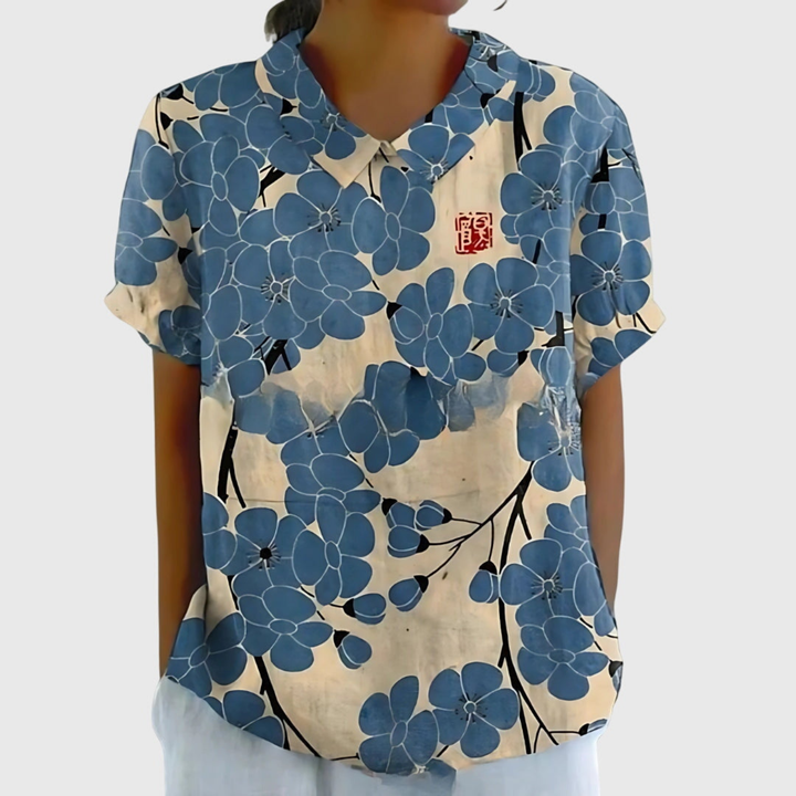 Flowy short sleeve floral print blouse in motion. Comfortable, casual chic, ideal for warm weather.