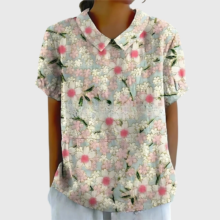 Close-up of vibrant floral print on a women's collared blouse. Warm weather, comfortable fashion.